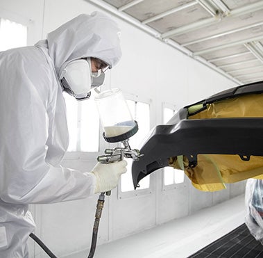 Collision Center Technician Painting a Vehicle | Flow Toyota of Statesville in Statesville NC